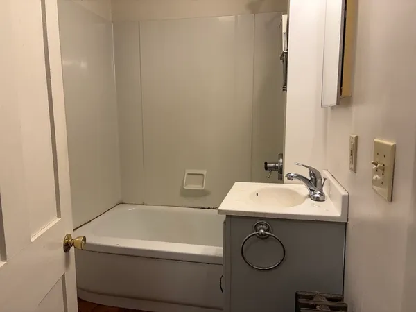 a bathroom with a granite countertop sink a mirror and vanity