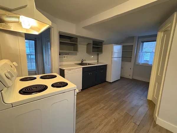 a kitchen with a sink a stove and refrigerator