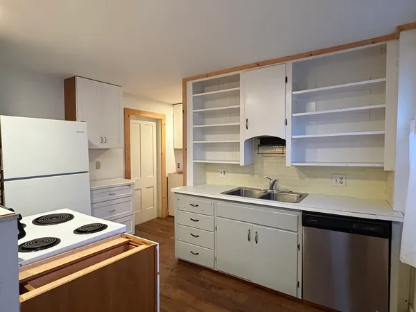 a kitchen with a sink stove and cabinets