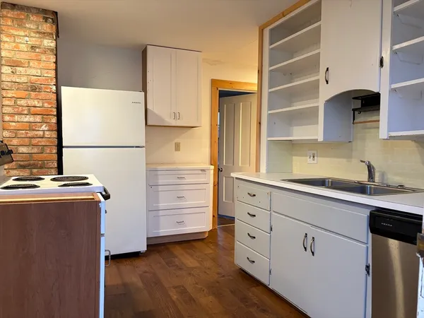 a kitchen with cabinets appliances and a window