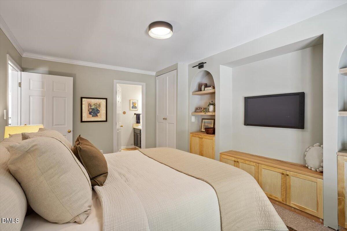 835 Madison Avenue Cary, NC 27513 - Photo 13 of 33 a bedroom with a bed and a flat screen tv