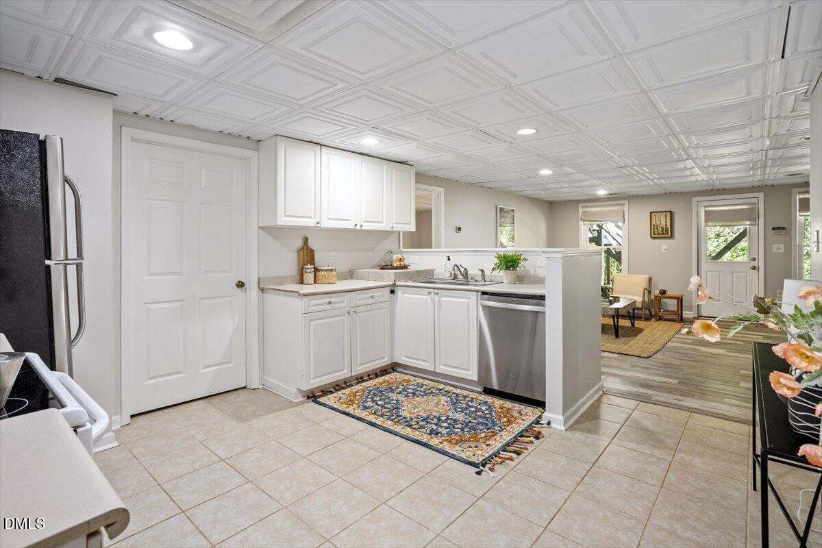 835 Madison Avenue Cary, NC 27513 - Photo 19 of 33 a kitchen with a sink a counter top space stainless steel appliances and cabinets
