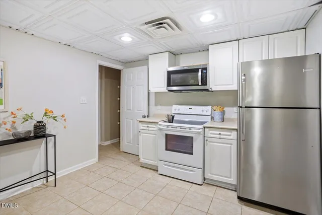 a living room with furniture and kitchen view