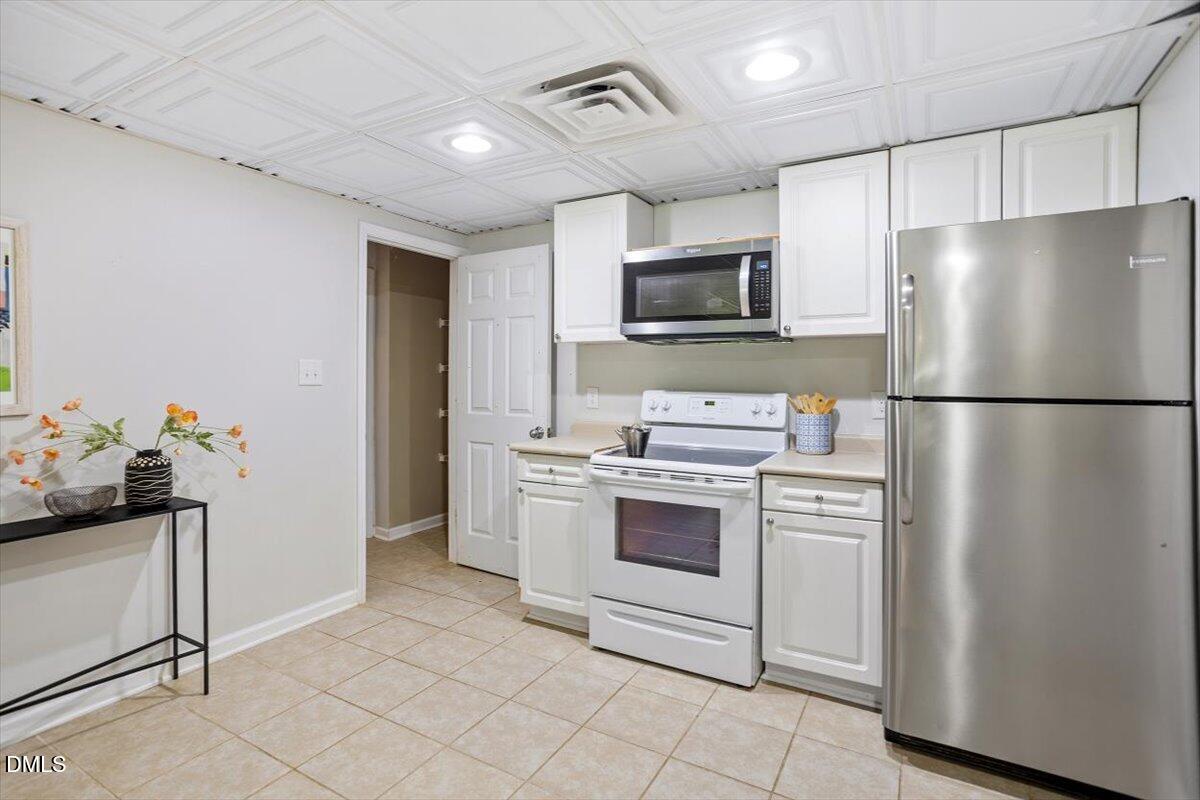 835 Madison Avenue Cary, NC 27513 - Photo 21 of 33 a kitchen with stainless steel appliances a refrigerator sink and microwave