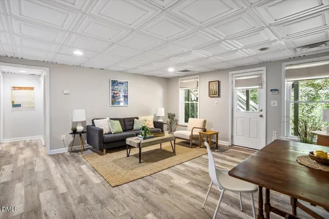 a bedroom with a bed and a lamp on dresser