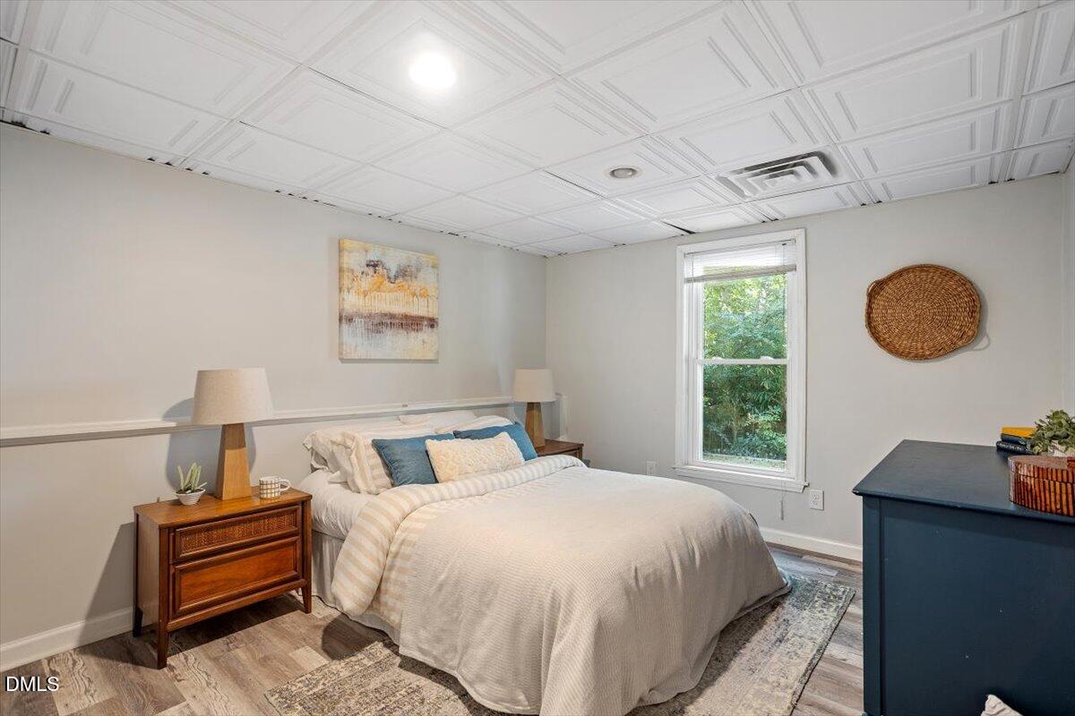 835 Madison Avenue Cary, NC 27513 - Photo 25 of 33 a bedroom with a bed and a lamp on dresser