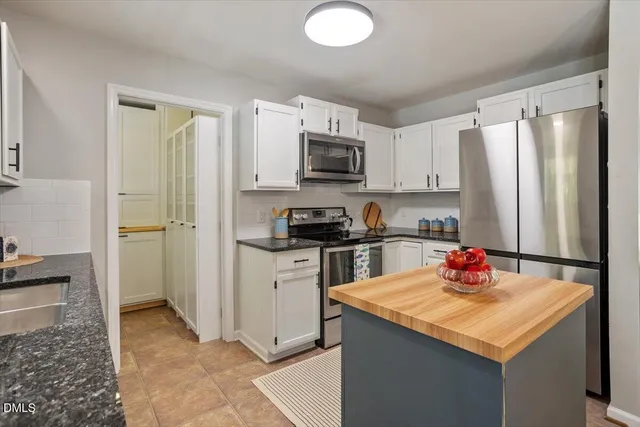 a view of a kitchen with sink and cabinets