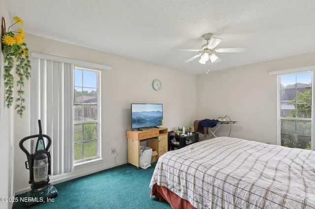 a bedroom with a bed dresser and a window