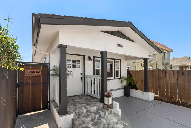a view of a house with a glass door and wooden floor