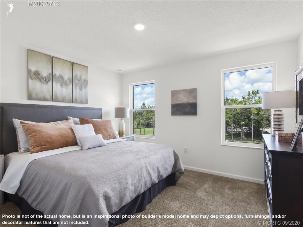 357 Southeast Angler Drive Stuart, FL 34994 - Photo 6 of 10 a bedroom with a bed and windows