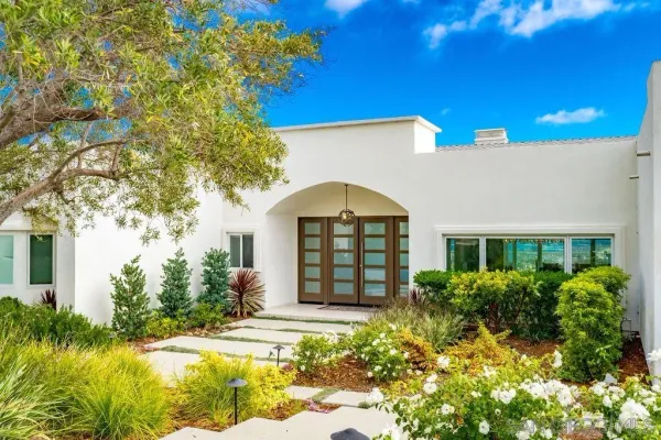 a front view of a house with garden