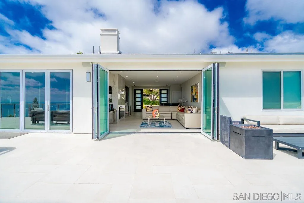 1001 La Jolla Rancho Road La Jolla, CA 92037 - Photo 18 of 47 a view of a living room and kitchen with a large window