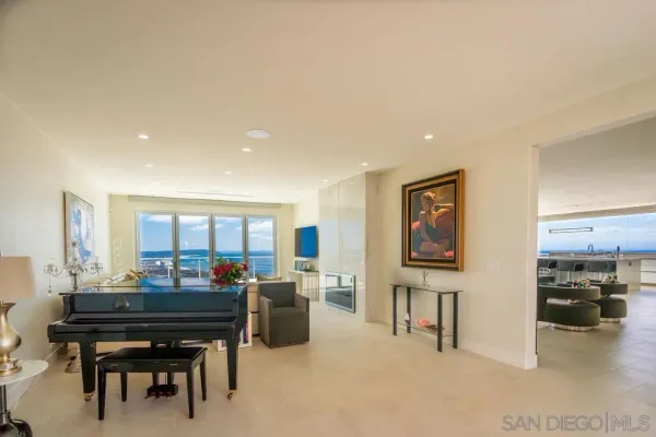 a room with furniture a piano and a flat screen tv