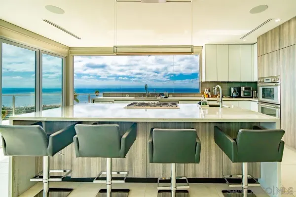 a view of a kitchen with a window and chairs