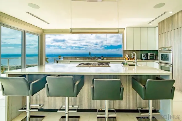 a view of a kitchen with a window and chairs