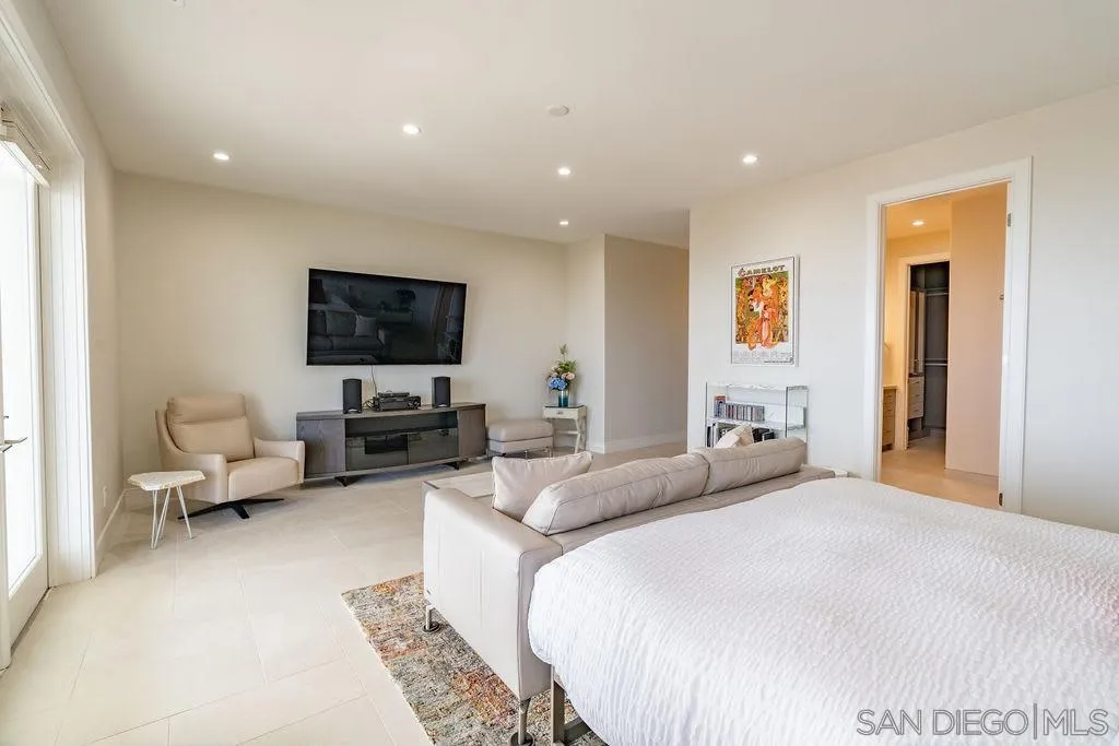 1001 La Jolla Rancho Road La Jolla, CA 92037 - Photo 28 of 47 a bedroom with a bed a couch and a flat screen tv