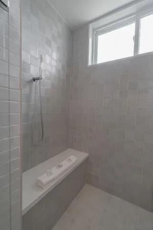 a bathroom with a bathtub and shower