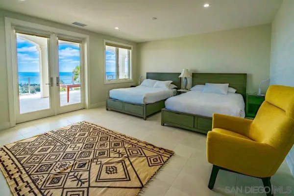 a bedroom with two beds and a couch