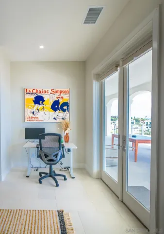 a view of a workspace with furniture and a window