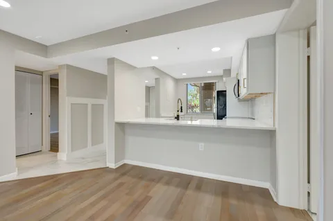a view of empty room with wooden floor