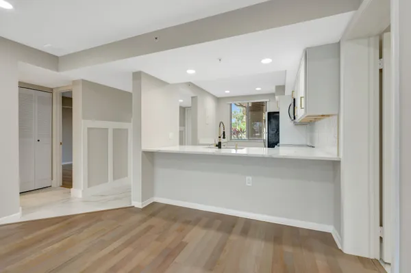 a view of empty room with wooden floor