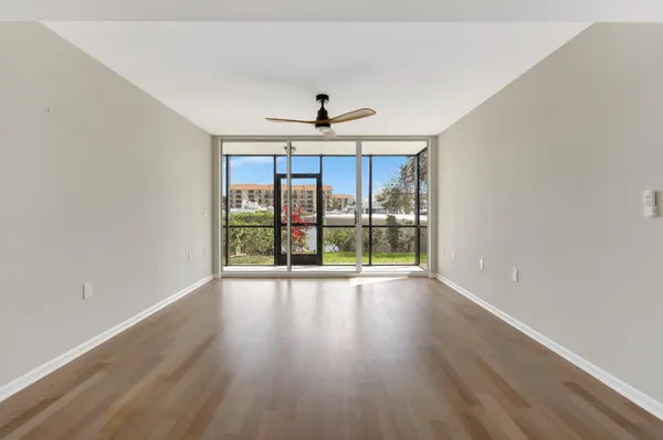 a view of room with window and wooden floor