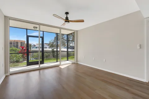 a view of empty room with wooden floor
