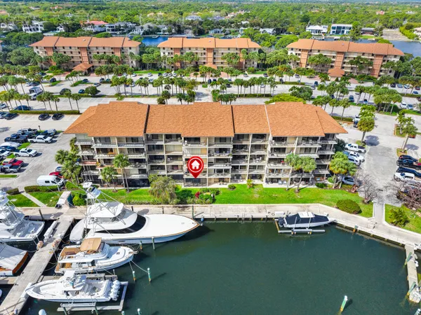 an aerial view of a house with a garden and lake view