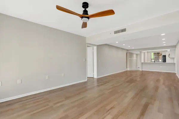 a view of room with window and wooden floor
