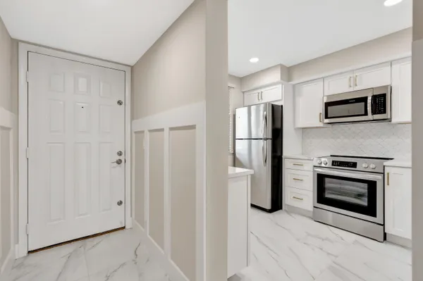 a kitchen with stainless steel appliances a refrigerator stove and microwave