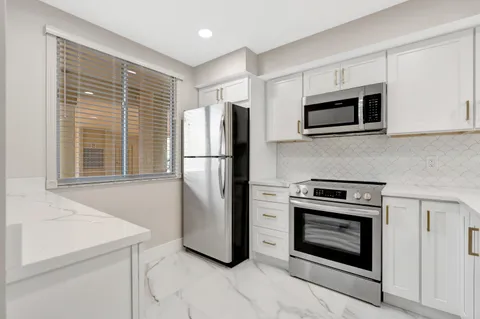 a kitchen with stainless steel appliances a stove a microwave and a refrigerator