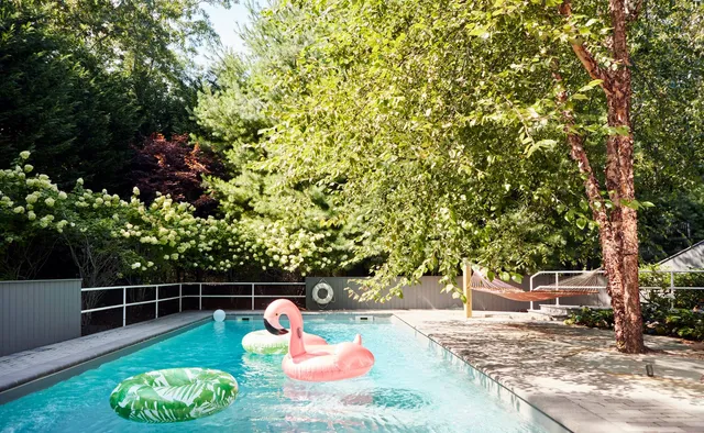 a backyard of a house with table and chairs