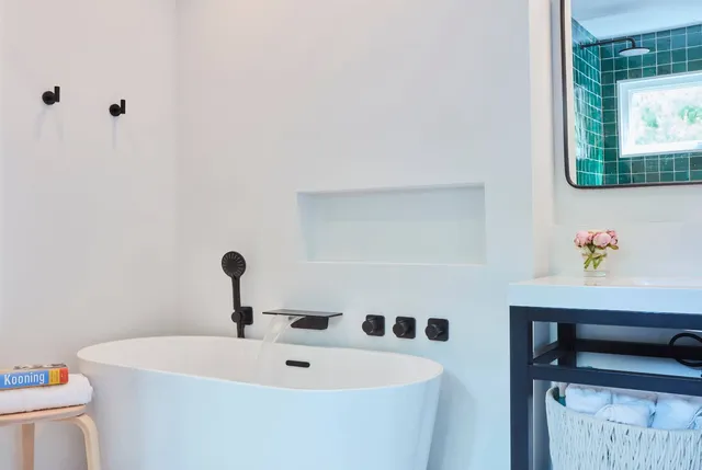 a bathroom with a tub and a sink