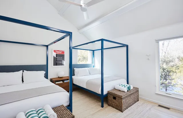 a bedroom with double bed and a window