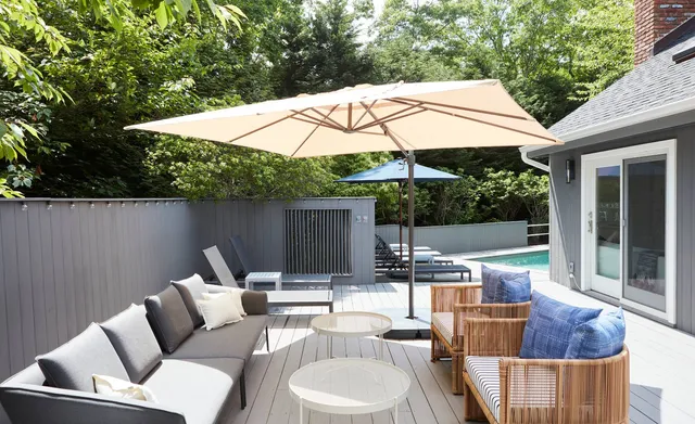 a patio with patio a table and chairs under an umbrella