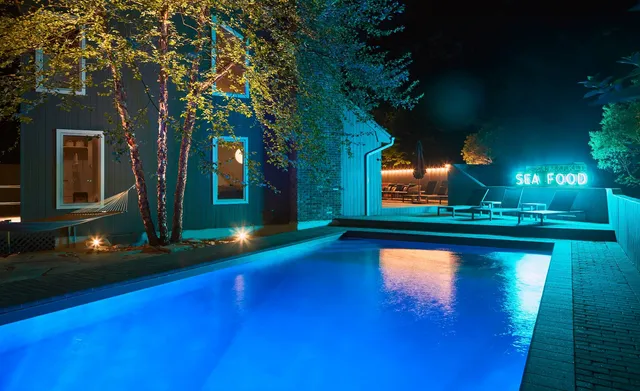 a view of a swimming pool with an outdoor space and seating area