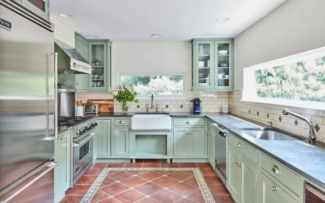 a kitchen with stainless steel appliances granite countertop a sink and a stove