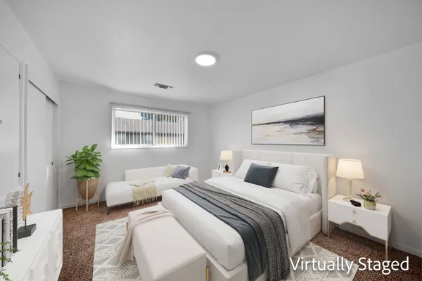 a bedroom with a balcony a large bed and a couch