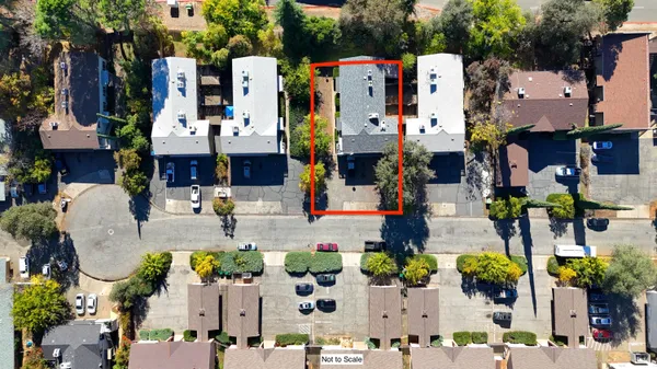 an aerial view of multiple houses with outdoor space