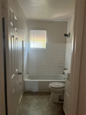 a bathroom with a toilet a sink and shower