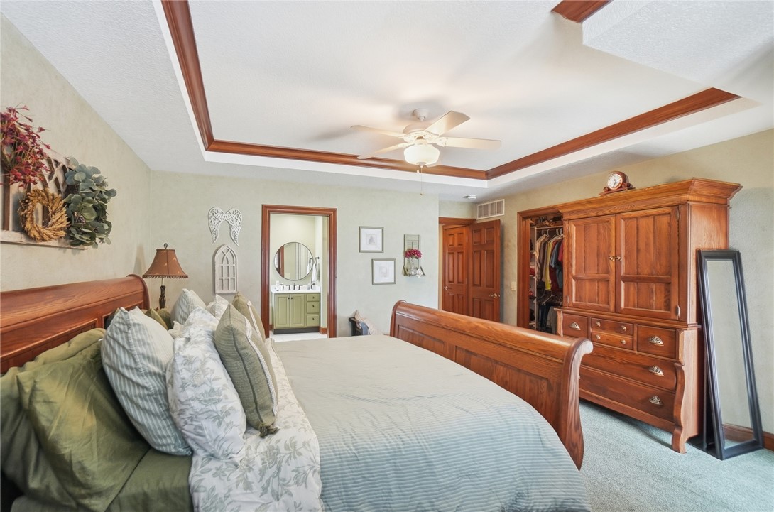 5300 Brookshire Lane Springfield, OH 45502 - Photo 28 of 56 This primary bedroom features a unique tray ceiling, recessed lighting, and direct access to a private bathroom.