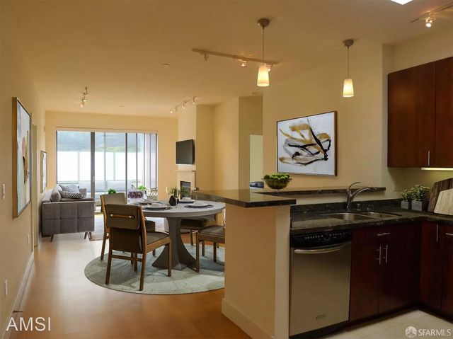 a kitchen with a table chairs stove and cabinets