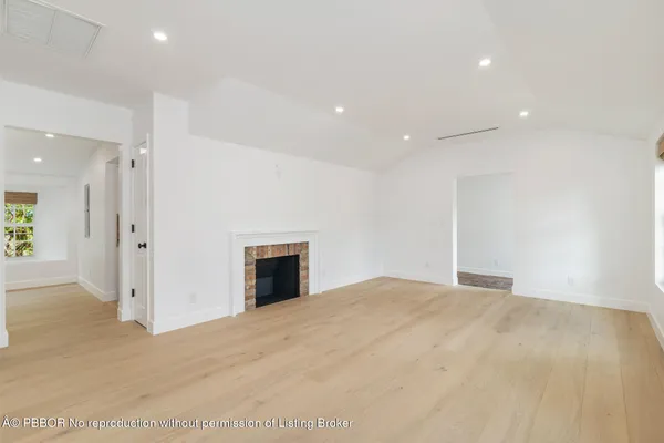a view of an empty room with a fireplace