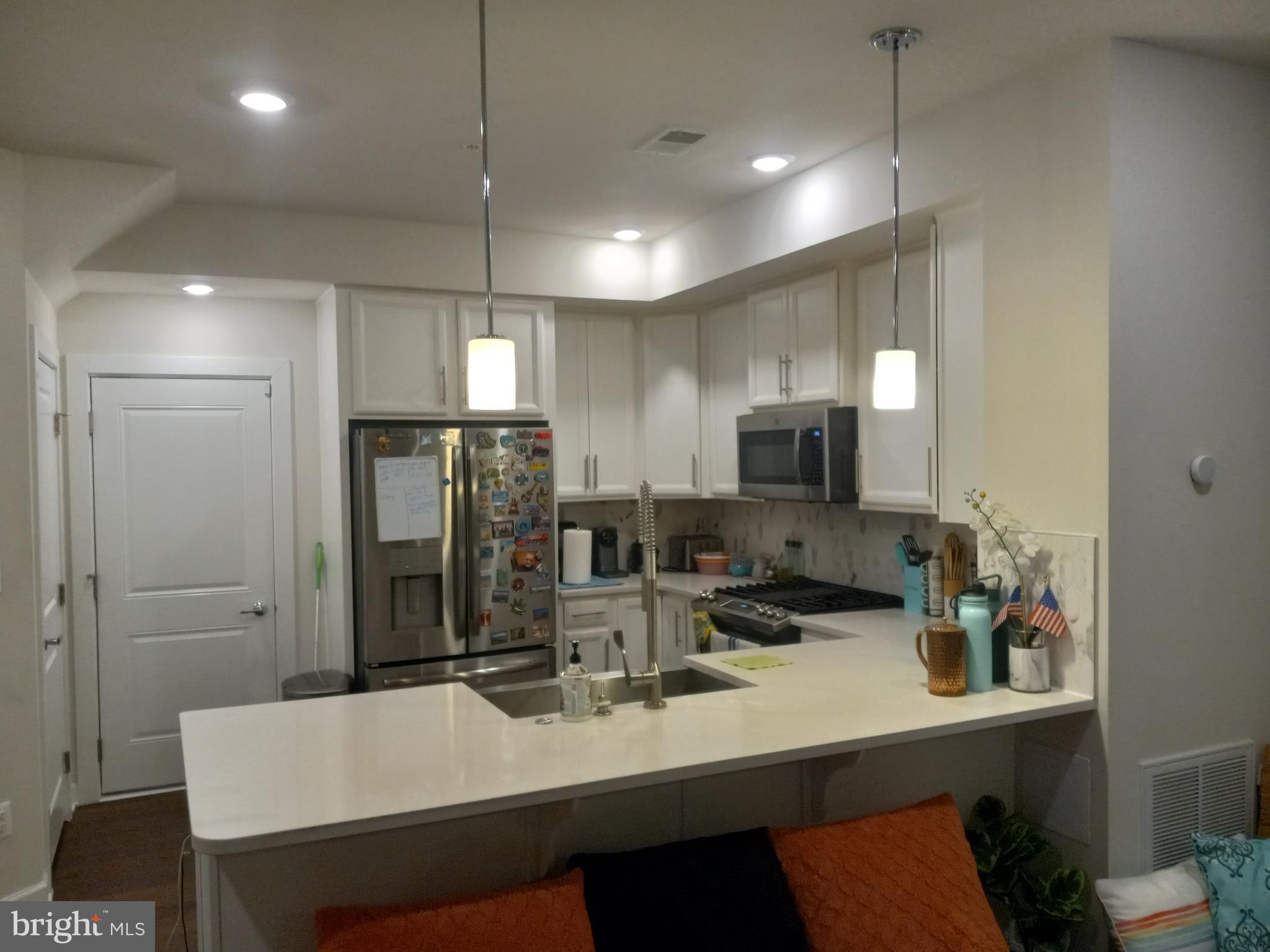 44682 Provincetown Drive Ashburn, VA 20147 - Photo 13 of 13 a kitchen with refrigerator and cabinets