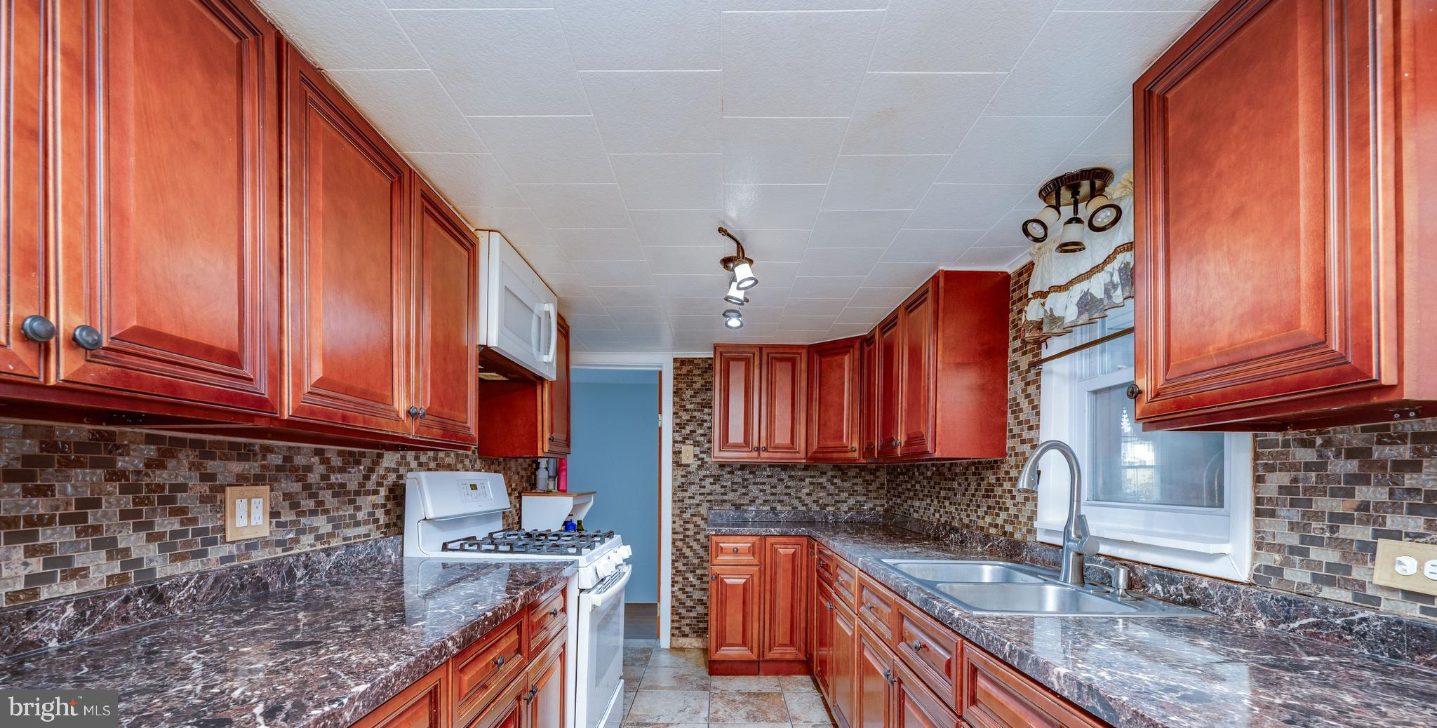1108 Liberty Avenue Reading, PA 19607 - Photo 4 of 24 a kitchen with stainless steel appliances granite countertop a sink a stove and cabinets