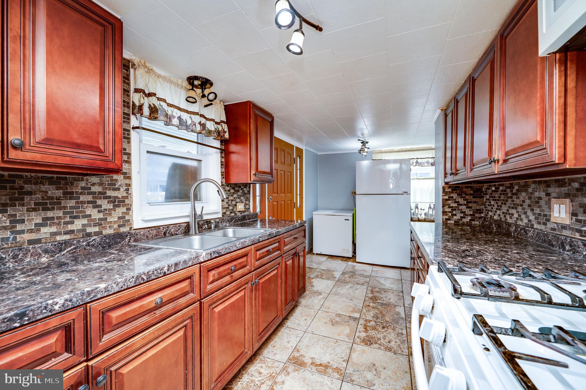 1108 Liberty Avenue Reading, PA 19607 - Photo 5 of 24 a kitchen with granite countertop a sink stove and cabinets