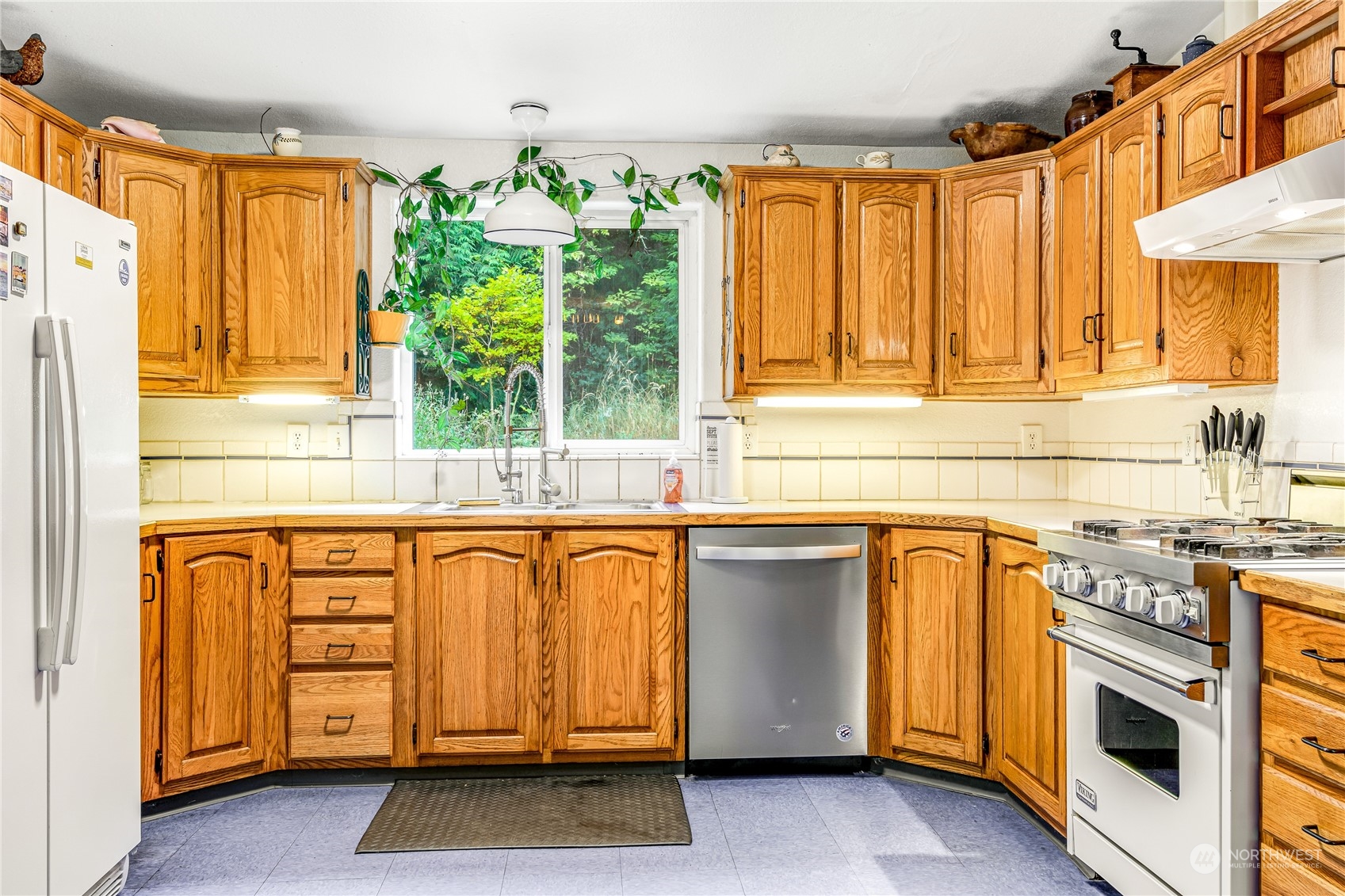 142 Ash Loop Port Townsend, WA 98368 - Photo 13 of 29 a kitchen with stainless steel appliances granite countertop a stove a sink and a microwave