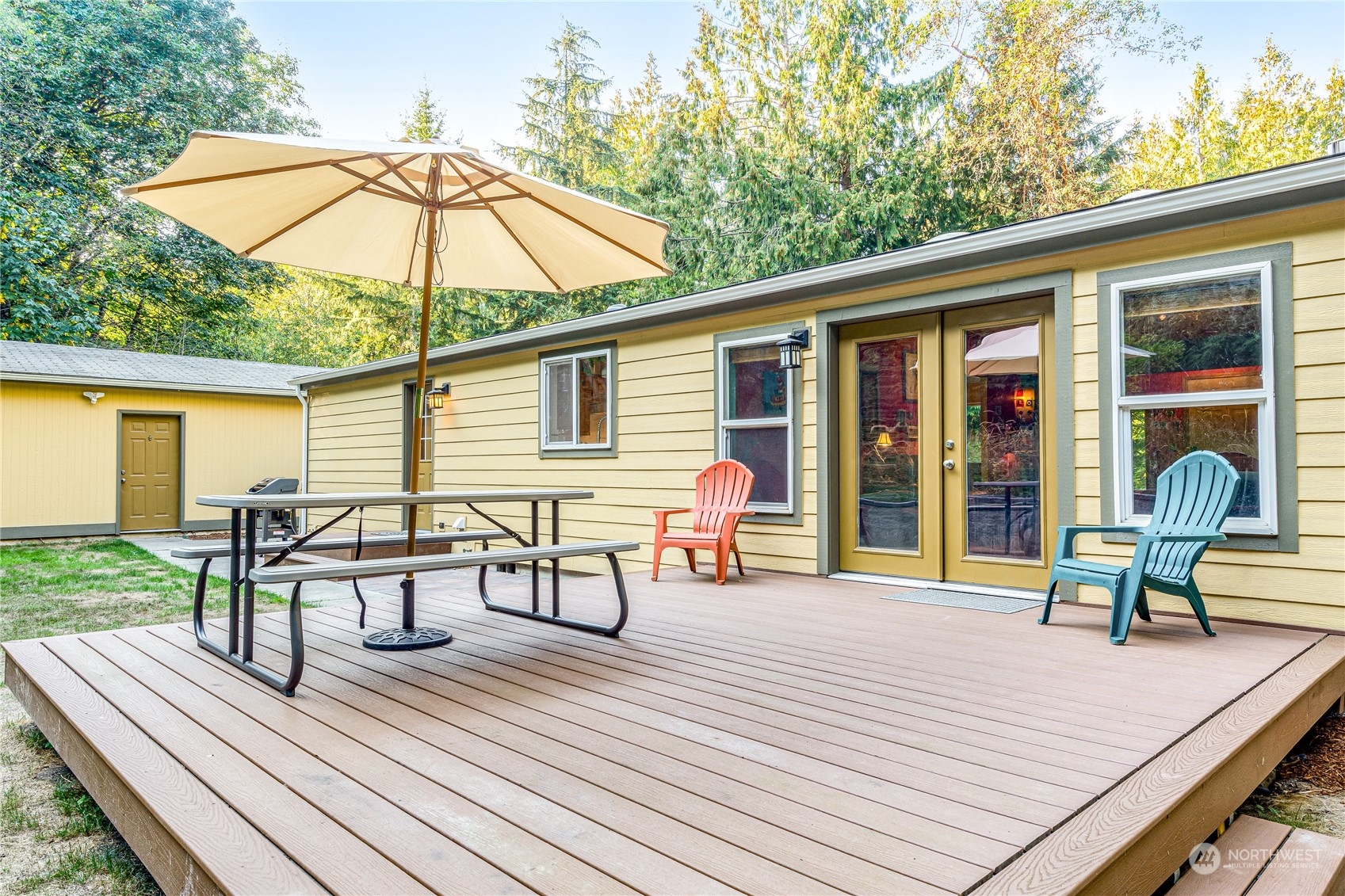 142 Ash Loop Port Townsend, WA 98368 - Photo 3 of 29 a view of a roof deck with table and chairs under an umbrella with wooden floor