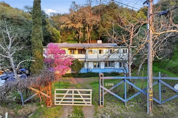 a view of a house with a yard and sitting area