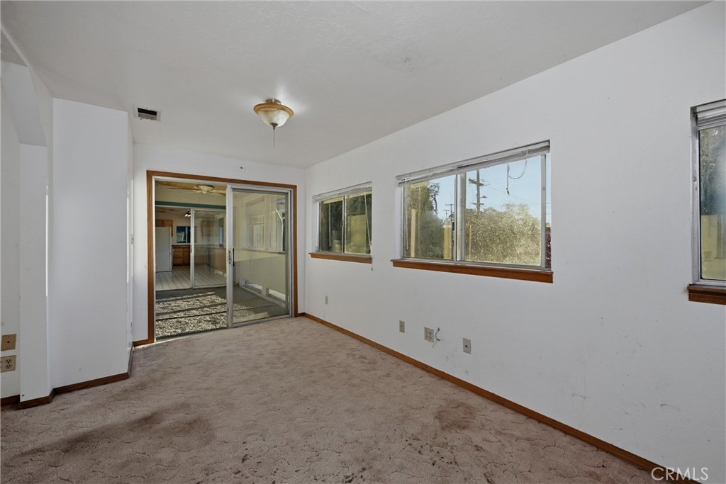 3398 Ogden Road Lucerne, CA 95458 - Photo 18 of 39 a view of an empty room with window and wooden floor